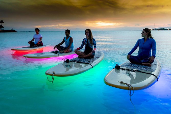 Night SUP Yoga in Honolulu, Hawaii - A gentle yoga flow with Honolulu above you