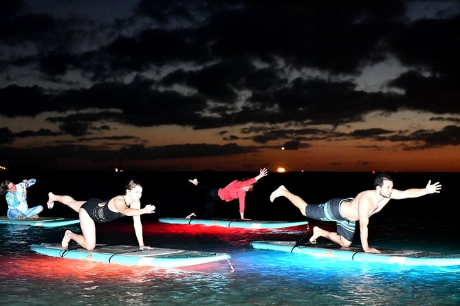 Night SUP Yoga in Honolulu, Hawaii - Learning to balance on the illuminated boards
